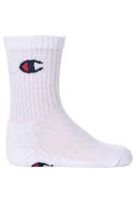 Calzino bianco in cotone con cavigliera a coste. Presenta un logo nero e rosso sul lato. Texture liscia, punta senza cuciture e bordino elastico.