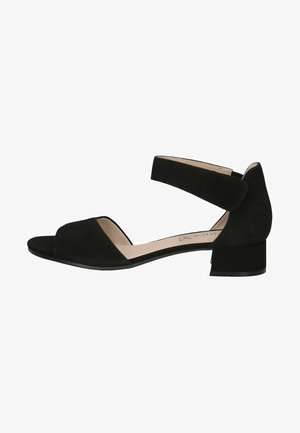 Schwarze Wildleder-Sandale mit offener Zehenpartie, breitem Vorderriemen und Knöchelband. Verfügt über einen niedrigen Blockabsatz für Unterstützung und minimalistisches Design.