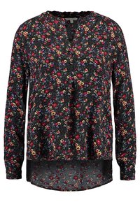 Långärmad blus i svart tyg, med ett blommönster i röd, gul och blå. V-ringning och något kurvad nederkant.