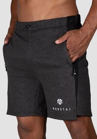 Dark gray athletic shorts made of cotton blend. Features include an elastic waistband, side pockets, and a white logo on the left leg.
