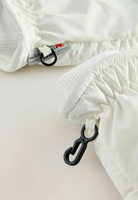 White padded gloves with ribbed edges, featuring black hardware attachments for adjustable fit and secure fastening. Smooth, glossy texture.