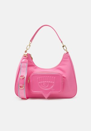 Pink nylon handbag with a glossy pink eye-shaped detail on the front, short shoulder strap, and gold-tone hardware accents.