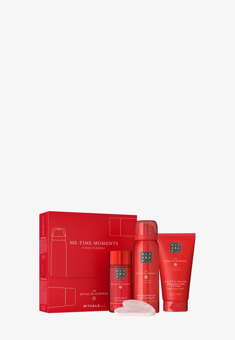Rituals Ayurveda set with rich bath oil, foaming shower gel, body & face clay mask, and a gua sha tool beside a red "Me-Time Moments" box.