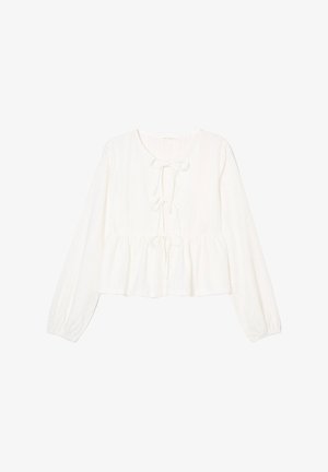 Hvid bomuldsbluse med lange, let puffede ærmer, rund halsudskæring og frontknude. Struktureret stof med huller i et ensartet mønster.