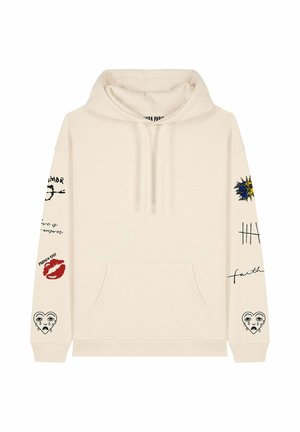 Hoodie couleur crème avec une poche avant, graphiques brodés sur les manches et capuche avec cordon de serrage. Présente des motifs divers et du texte.