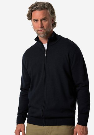 Marine blauw ritssluiting cardigan gemaakt van een gebreid materiaal. Heeft een hoge kraag, ribgebreide manchetten en onderkant, met een gladde textuur en een aansluitend ontwerp.