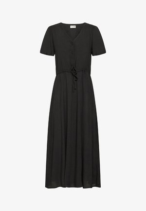 Juoda suknelė iki kelių, trumpomis rankovėmis, V formos iškirpimu, mygtukais priekyje ir reguliuojamu raiščiu juosmenyje. Pagaminta iš lengvos medžiagos, su laisvu siluetu.