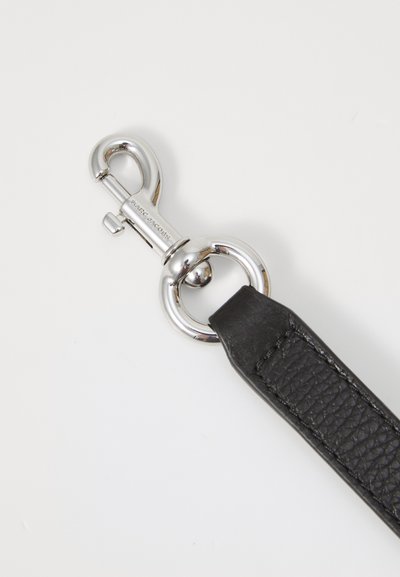 Black leather strap with textured surface, silver metal snap hook, and large circular ring attachment.