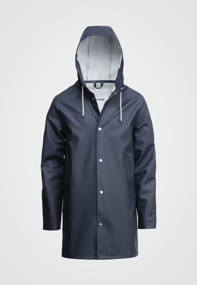 Navy blue waterproof raincoat with a hood, pocket flaps, silver snap buttons, and a smooth texture. Interior features a contrasting light color.