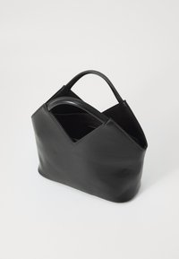 Black leather handbag with a triangular design, smooth texture, dual handles, and an open top. Interior visible, showcasing organization potential.