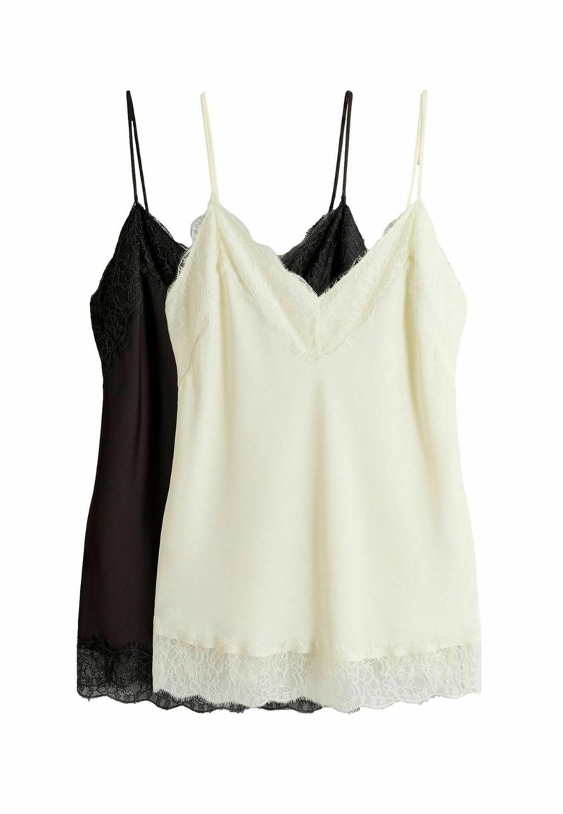 Two camisoles stacked; one black, one cream. Both feature lace trim along the v-neckline and hem, with adjustable straps.