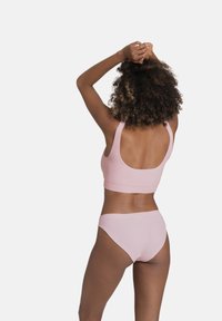 Light pink ribbed bikini set featuring a sleeveless top and high-waisted bottoms, with soft texture and minimalist design details.
