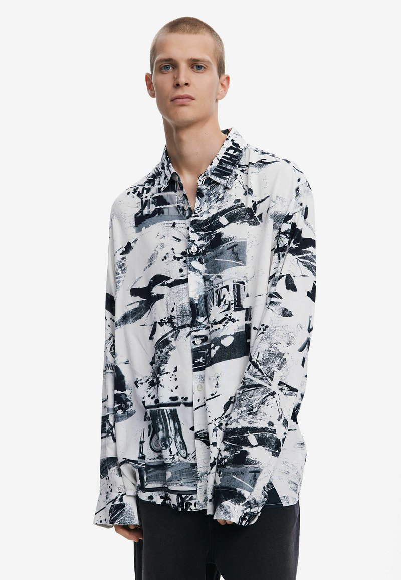 Black and white printed long-sleeve shirt featuring abstract patterns, button-up front, and relaxed fit. Made of lightweight fabric.