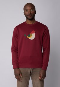 Bordeaux sweatshirt met een kleurrijke vogelafbeelding in rood, geel, groen en zwart. Gemaakt van zachte stof met ribgebreide manchetten en zoom.