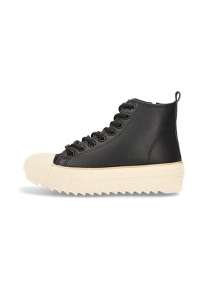 Zapatilla alta negra con suela zigzag gruesa beige, puntera beige, cordones negros y tirador sobre fondo blanco.