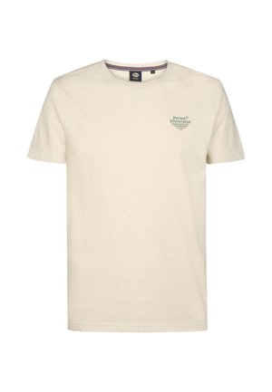 Krátký rukáv krémového bavlněného trička s tečkovanou texturou a zeleným potiskem loga na levé straně hrudi. Klasický design s kulatým výstřihem.