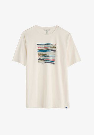 T-shirt in cotone color crema con un grafico rettangolare caratterizzato da linee ondulate nei toni del blu, verde, grigio e rosso. Maniche corte, vestibilità comoda.