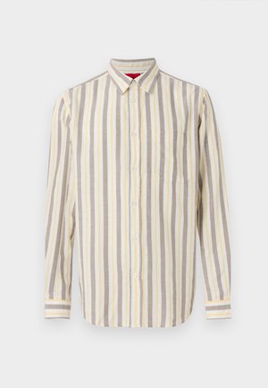 Chemise à manches longues avec boutons, rayures verticales beige, blanches et jaune clair, et une poche poitrine unique sur un fond uni.
