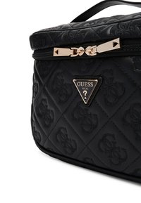 Bolso de cosméticos negro acolchado con un patrón de logotipo en relieve, que cuenta con un cierre de cremallera en tono dorado y herrajes decorativos.