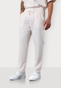 Leichte, gemusterte Sweatpants aus weichem Stoff, mit elastischem Bund und Kordelzug, seitlichen Taschen und schmal zulaufenden Beinen.