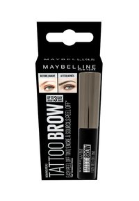 L'emballage de Maybelline Tattoo Brow présente un fond noir avec des textes en blanc et en argent, mettant en valeur un teinture à sourcils et des images avant/après.