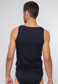 Mörkblå randig linne med avslappnad passform, med rund halsringning och breda ärmhål, tillverkat av ett mjukt och lätt tyg.