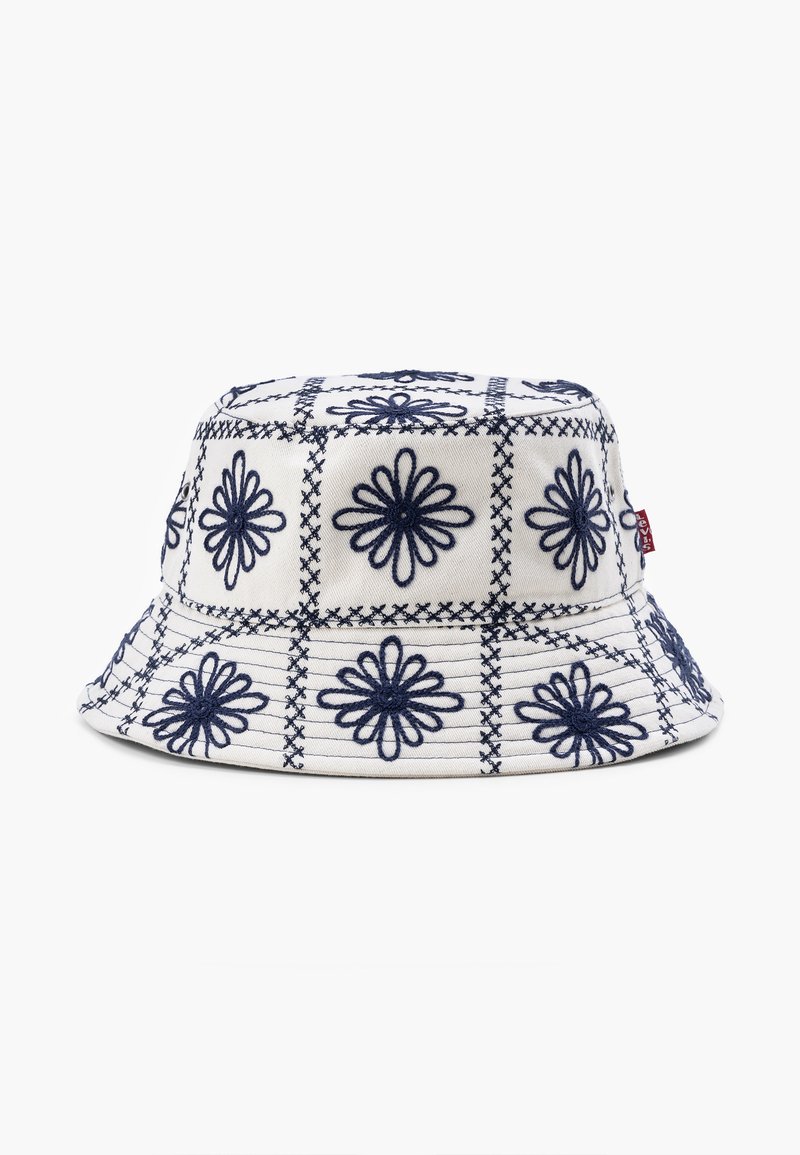 Bucket Hat aus cremefarbener Baumwolle mit navyblauer Blumenstickerei in einem Rautenmuster. Runde, flache Krone und breiter, nach unten geneigter Rand.