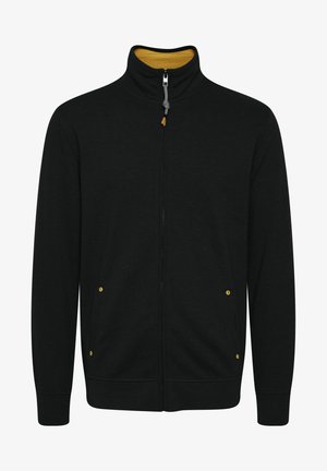 Črna zip-up jakna z visokim ovratnikom, z rumenim podlogom, stranskimi žepi z rumenimi detajli in rebrastimi manžetami.