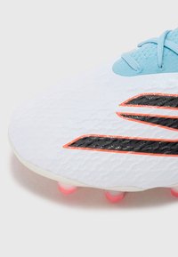 White soccer cleat with textured upper, black and orange accent stripes, light blue laces, and pink-tinted studs.