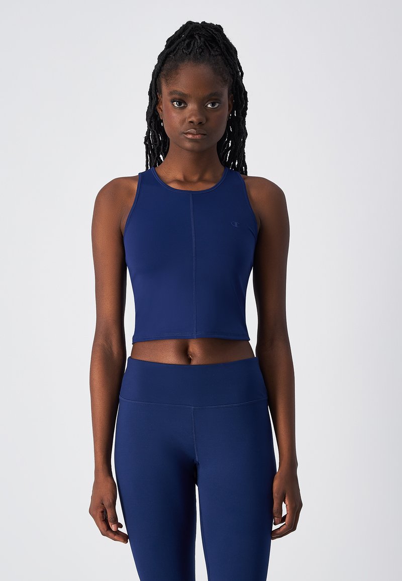 Navy cropped sporttop met een ronde halslijn en racerback ontwerp. Gemaakt van rekbaar materiaal, met platte naden voor comfort.