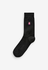 Black cotton sock with a smooth texture, featuring a small pink, cartoon character embroidery near the ankle. Classic crew length design.