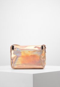 Borsa metallica rosa con una superficie liscia, forma rettangolare, chiusura superiore a zip e una tasca esterna. Leggera lucentezza iridescente.