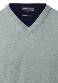 Sweter w serek w jasnozielonym kolorze, wykonany z mieszanki organicznej bawełny i kaszmiru. Posiada ściągacz przy kołnierzyku oraz gładką fakturę. Rozmiar M.
