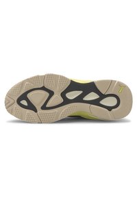 Podešev boty má strukturovanou béžovou gumovou základnu s černým akcentem a zelenými detaily. Kulatý tvar s vzory pro trakci pro lepší přilnavost.