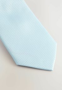 Light blue tie made of textured fabric with a geometric pattern, tapered end, and smooth finish. Suitable for formal wear.