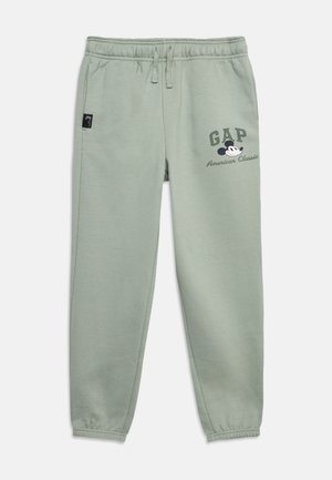 Ανοιχτό πράσινο παντελόνι φόρμας με ελαστικές μανσέτες και μέση, εμπρόσθιες τσέπες, λογότυπο GAP και γραφικό Mickey Mouse με το κείμενο «American Classic» στον μηρό.