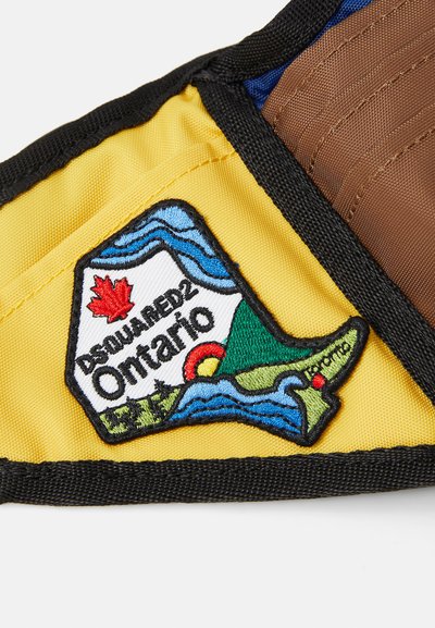 La toppa di tessuto gialla presenta un design ricamato dell'Ontario con una foglia d'acero rossa, onde blu e accenti di paesaggio verde. È bordata di nero.