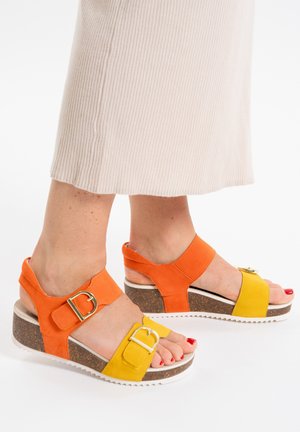Orange and yellow wedge sandals with a textured suede finish, featuring two adjustable straps and a cork sole with white accents.
