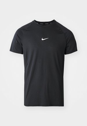 Black athletic T-shirt made of fabric with a textured pattern. Features short sleeves and a white Nike logo on the chest.