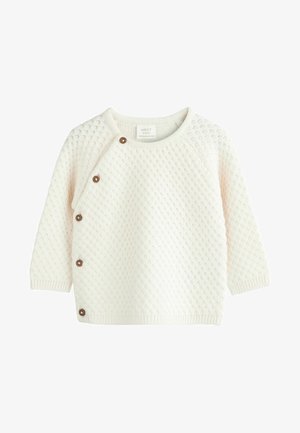 Krém színű, kötött baba pulóver, texturált mintával, kerek nyakkal és díszes barna gombokkal az oldalon. Hosszú ujjak.