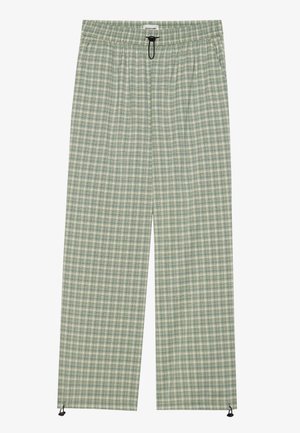 Green and cream plaid pants with an elastic waistband, drawstring detail, and ankle toggles. Made from lightweight fabric, featuring a relaxed fit.