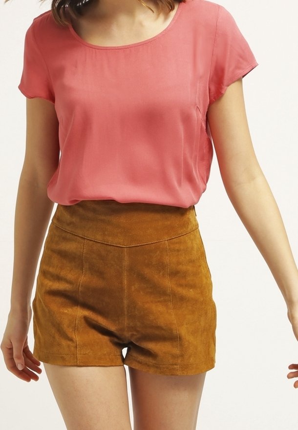 Coral silk top with short sleeves paired with brown suede high-waisted shorts, featuring a smooth texture and a fitted silhouette.
