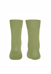 Dwie pary jasnozielonych skarpet leżących płasko, z widocznym prążkowanym mankietem i gładkim ciałem, podkreślających teksturę i styl.
