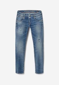 Blå slim-fit jeans med slidte pletter på forreste lårparti, fem-lommer stil og "HERITAGE" label på indvendig linning.