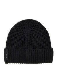 Donker marineblauwe gebreide beanie met geribbelde structuur. Heeft een opgerolde rand en een klein zwart label met witte tekst aan de zijkant.