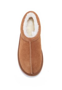 Suede slipper in a warm brown color, featuring a plush white fur lining, rounded shape, and minimal stitching detail.
