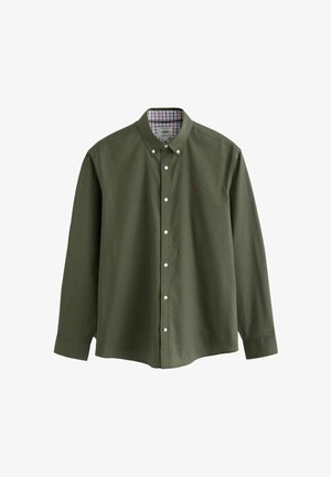 Chemise boutonnée vert olive à manches longues, avec des boutons blancs et un détail de col intérieur à carreaux. Texture en coton lisse avec un petit logo.