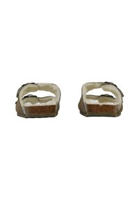 Sandales marron avec une semelle en liège, dotées d'une doublure intérieure douce et blanche ainsi que de sangles réglables de chaque côté pour un ajustement sécurisé.