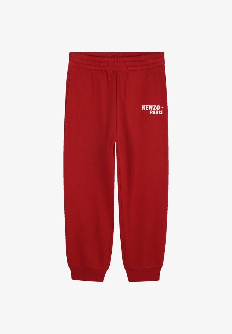 Pantalon de survêtement rouge avec une taille élastique, des poignets fuselés et le logo blanc "KENZO PARIS" sur la cuisse gauche. Fabriqué en doux tissu en mélange de coton.