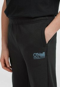 Zwarte sweatpants met een elastische tailleband, zijzakken en een lichtblauw "O'Neill Santa Cruz California U.S.A." logo op de heup.